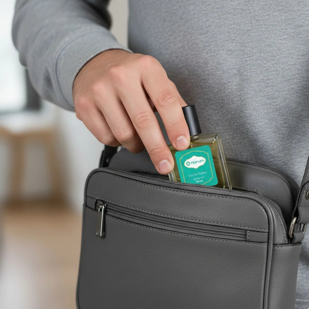 Man placing Harum.sg 30ml perfume bottle into bag pocket — compact, travel-friendly fragrance