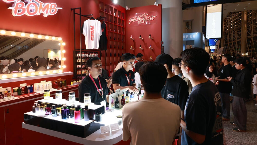 Customers browsing fragrances at the SugarBomb SG perfume store popup setup in Singapore.