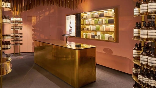 Elegant Harum.sg perfume boutique interior in Singapore featuring gold counter, warm lighting, and neatly arranged fragrance bottles