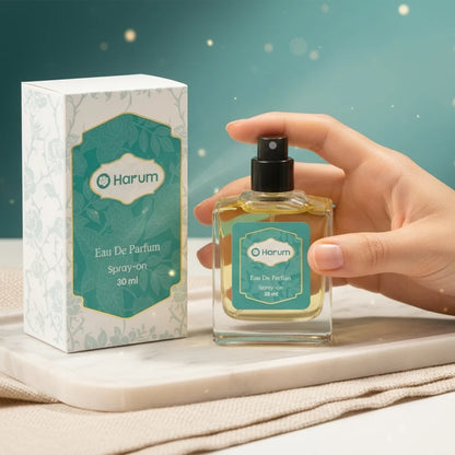 A 30ml bottle of Harum Eau De Parfum spray alongside its decorative floral packaging.