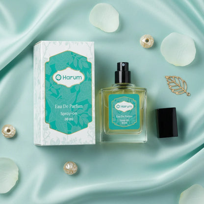 Harum.sg 30ml Eau De Parfum bottle and box displayed on mint satin background with petals and gold accessories