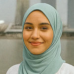 Person wearing a light green hijab with a blurred background