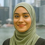 Person wearing a green hijab with a blurred background