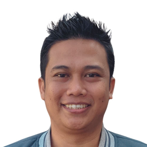 Man with spiky hair smiling against a white background