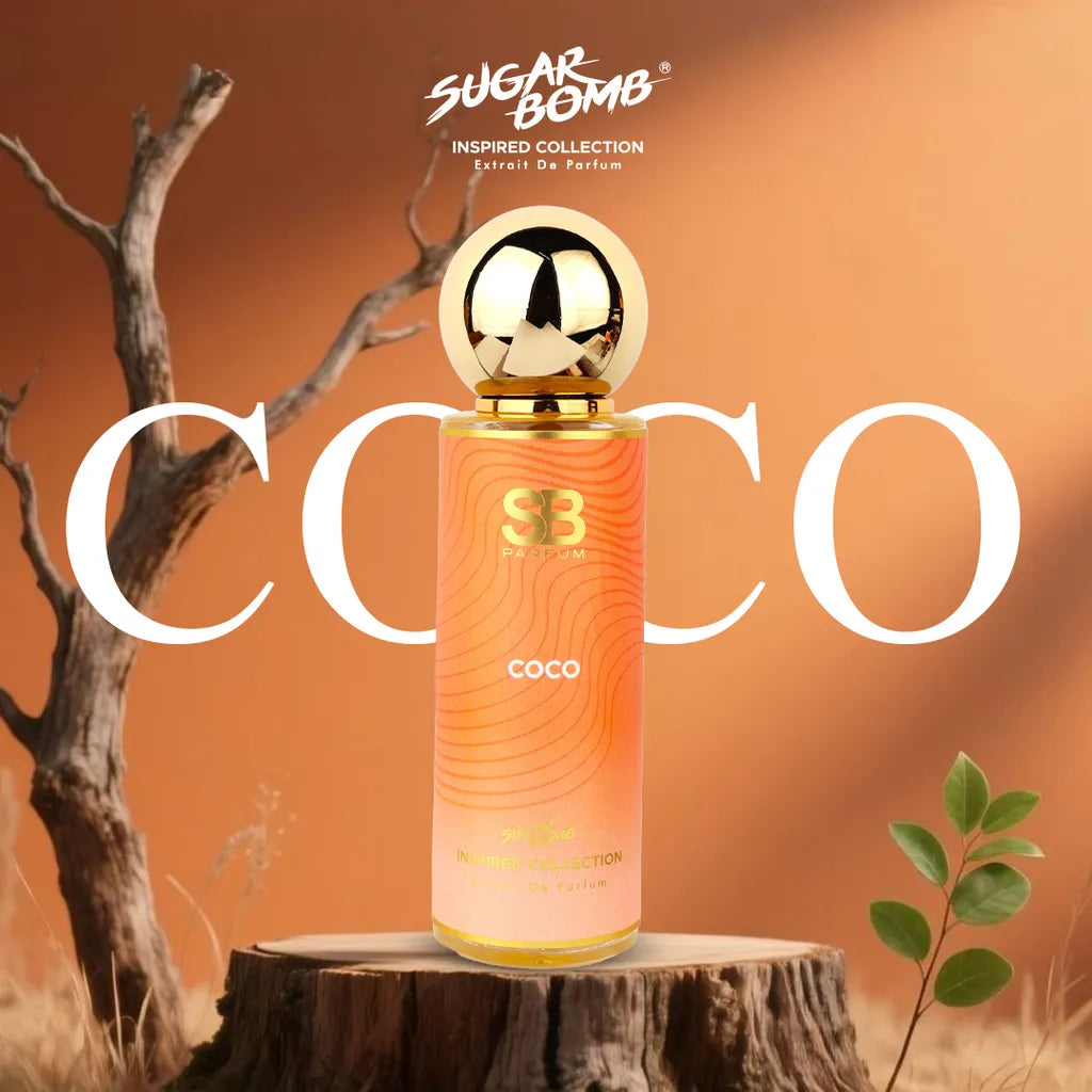 SugarBomb Coco Extrait De Parfum from the Inspired Collection, a warm oriental fragrance inspired by Chanel Coco Mademoiselle, displayed on a wooden tree stump background.