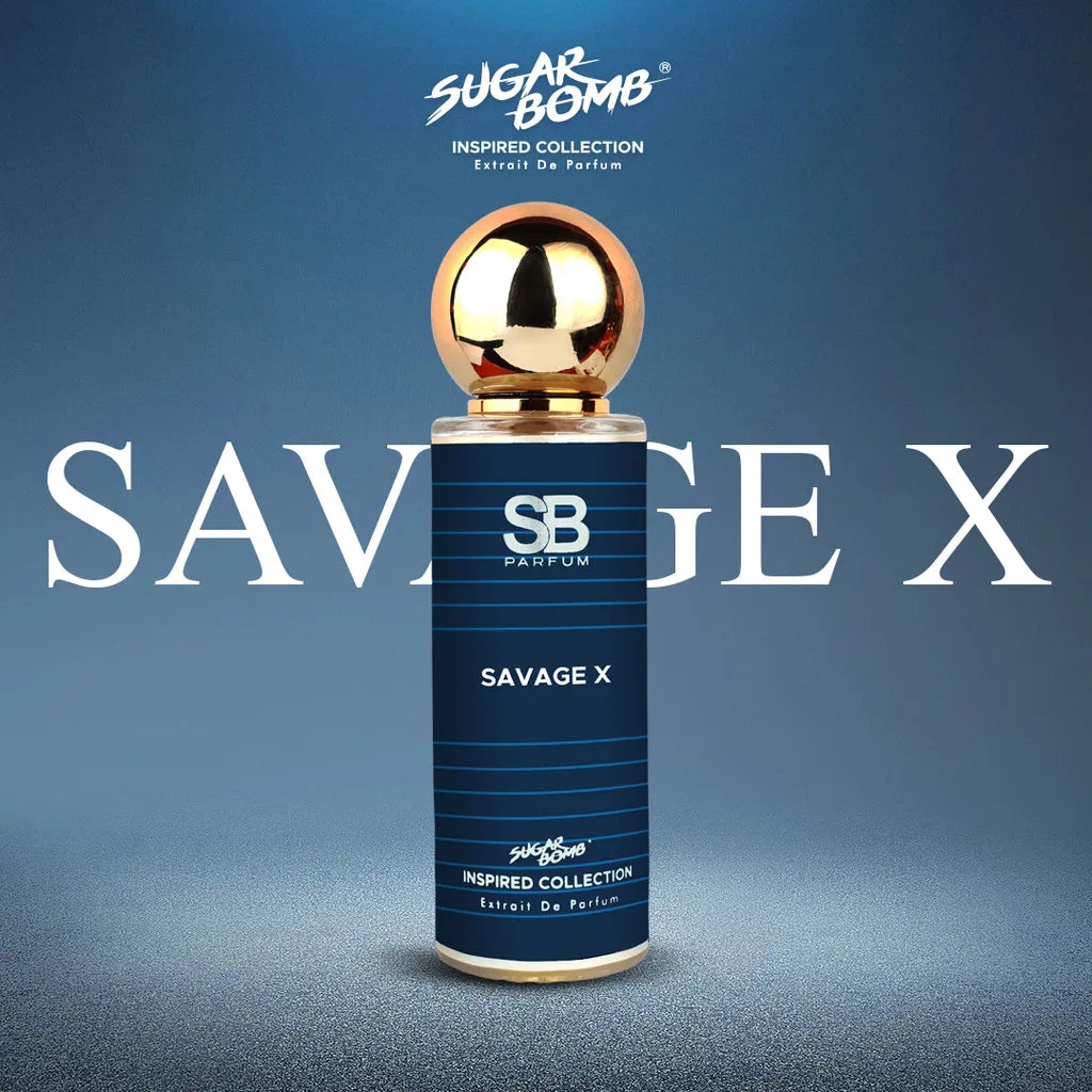 SugarBomb Savage X Extrait De Parfum bottle standing vertically in the center against a clean, textured blue studio background with a subtle spotlight effect. The bottle features a metallic gold spherical cap and a dark blue striped label with the SB Parfum logo. The text "SAVAGE X" is overlaid across the middle in large white serif lettering. The top of the graphic displays the SugarBomb Inspired Collection branding.