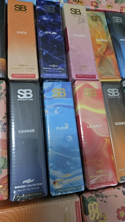 A variety of SugarBomb (SB) Parfum Inspired Collection boxes in 30ml sizes, featuring scents like Savage, Fleur, La Juicy, Coco, Dylan and Chance.