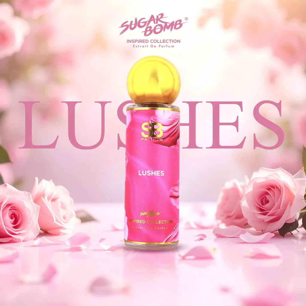 SugarBomb Lushes Extrait De Parfum bottle from the Inspired Collection, centered on a bright pink table surrounded by soft pink roses.
