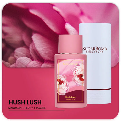 SugarBomb Signature Hush Lush Extrait de Parfum 100ml bottle and white cylinder packaging against a pink peony floral background.