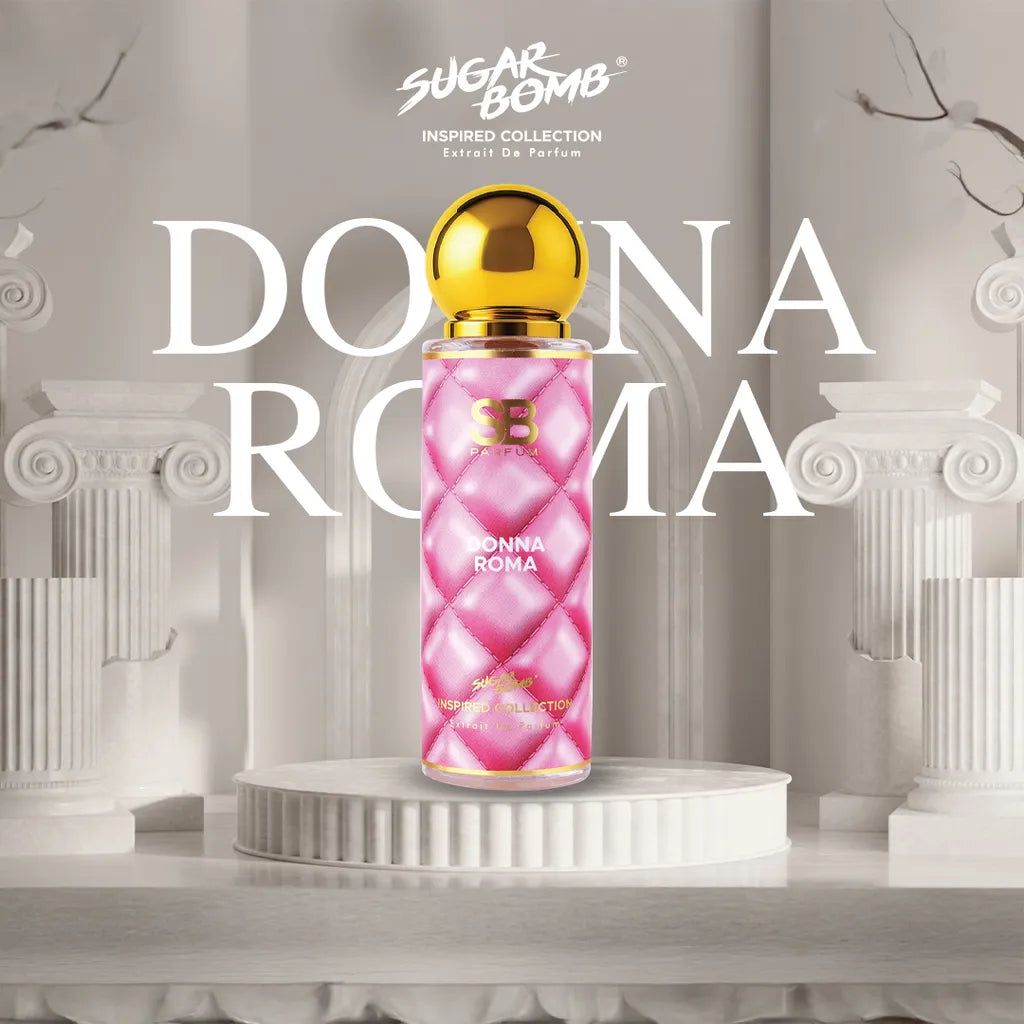 SugarBomb Donna Roma Extrait De Parfum bottle from the Inspired Collection, standing on a white pedestal flanked by ancient Roman-style marble columns.