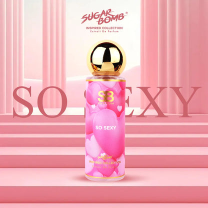 SugarBomb So Sexy Extrait De Parfum bottle from the Inspired Collection, featuring a pink heart-patterned label and a round gold cap, displayed against a pink background with classical columns and stairs.