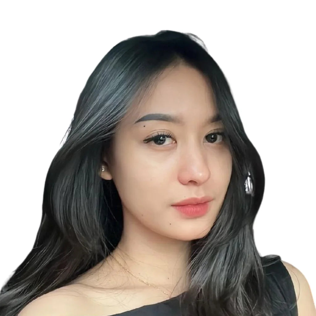 Yuna, a team member at Harum SG, featuring long dark hair and a black top against a white background.